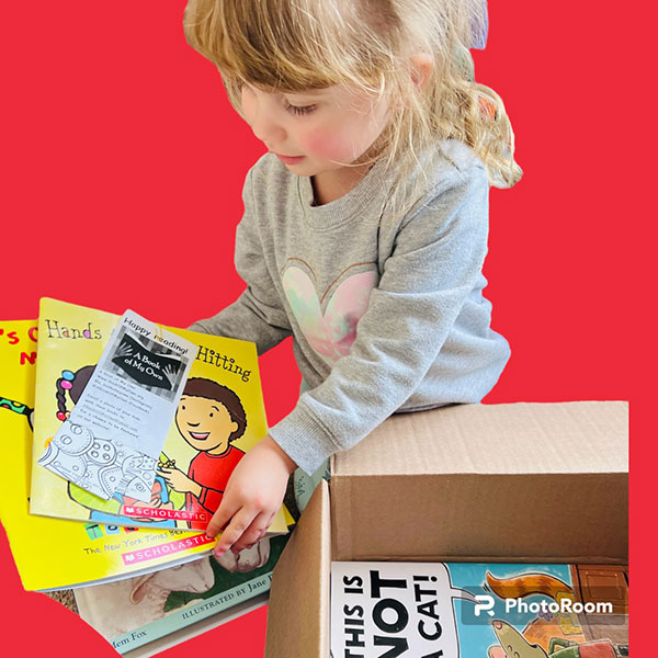 girl opening box of books